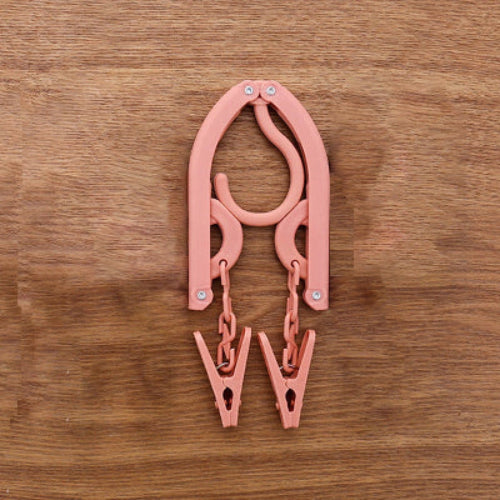 Cintre pliable rose avec deux encoche pour bretelle