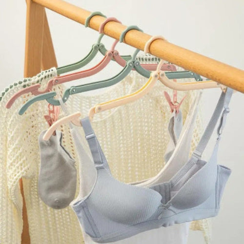 Cintre pliant efficace du soutien-gorge au manteau qui se glisse dans un sac sans prendre de place