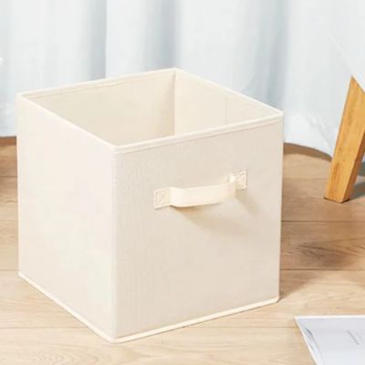 boite de rangement en tissu beige pose sol chambre poignée renforcée
