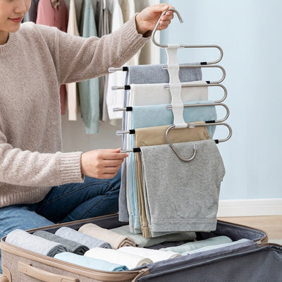 femme prépare valise avec cintre pantalon gain de place